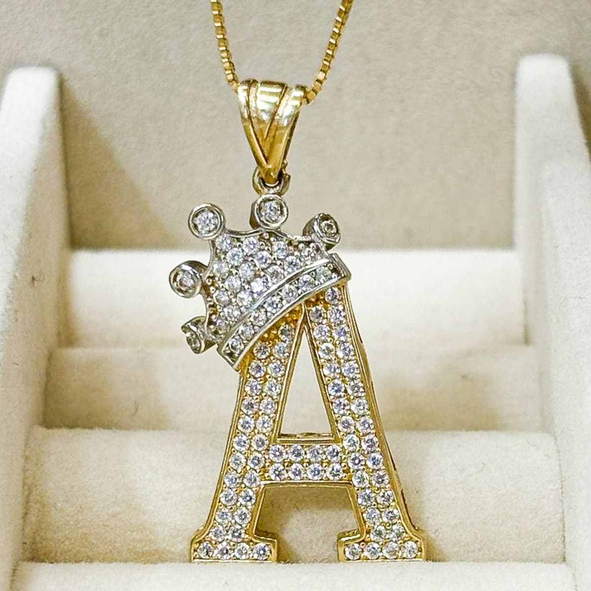 Custom gold letter 'A' pendant with crown design and diamond accents